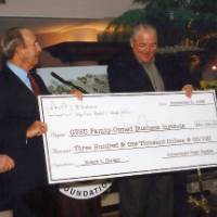 Richard DeVos with others receiving a check.